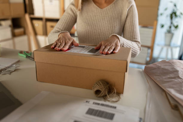 istock Making sure the label is sticking to the package 1301480120