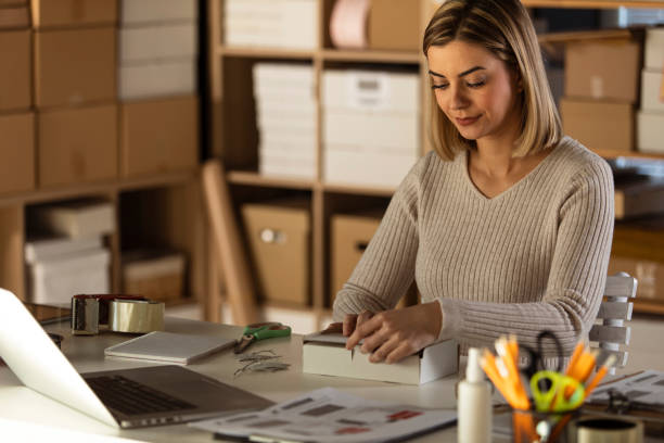istock Copy space of young woman assembling a cardboard box 1301480892