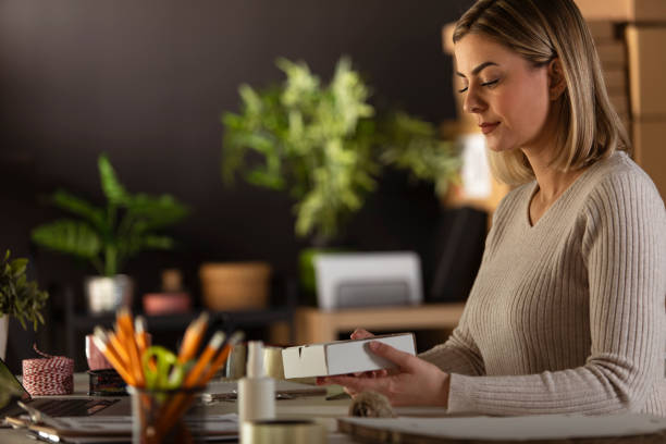istock Young female entrepreneur preparing a package for online customer 1301481307