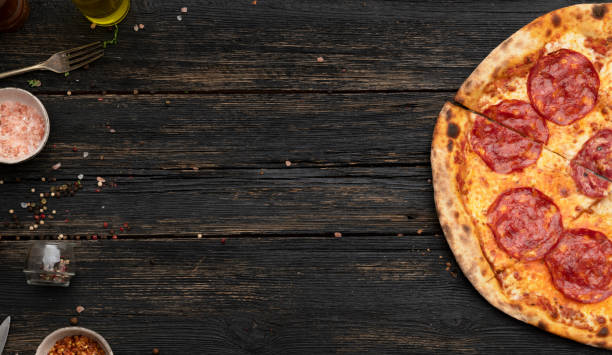 Pepperoni Pizza on wooden table Pepperoni Pizza on wooden table with space on text. Top view pizza stock pictures, royalty-free photos & images