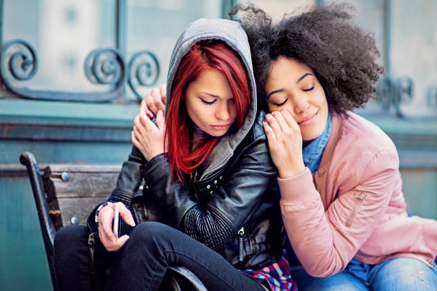istock Young woman is consoling her girlfriend after break up 1301486810