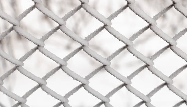 istock Metal mesh is covered with icicles close up - winter scenary 1301487881