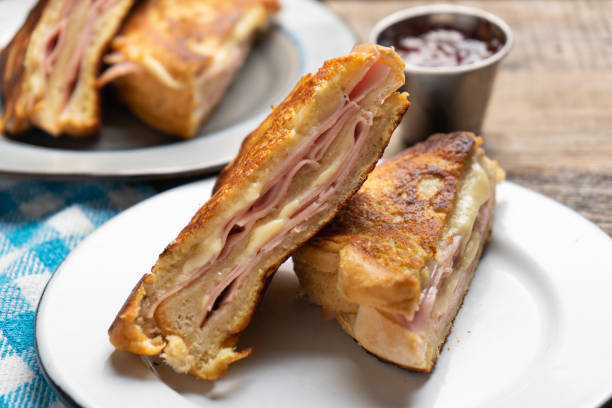 istock Ham and melted cheese sandwich called Monte Cristo on wooden background 1301488594