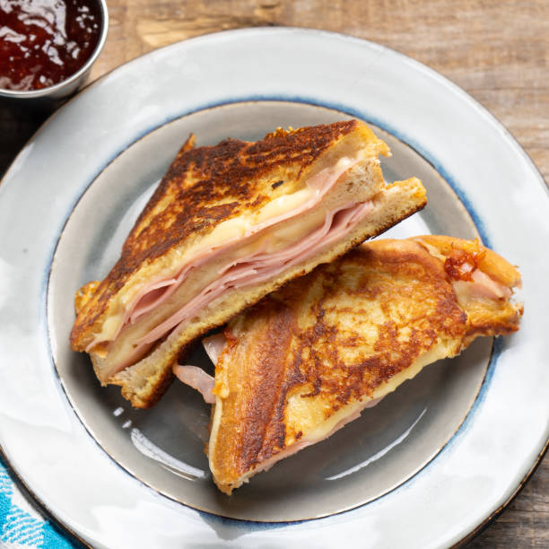 istock Ham and melted cheese sandwich called Monte Cristo on wooden background 1301488613