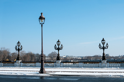 View to Alexandre III bridge with snow. Unusual weather conditions in Paris