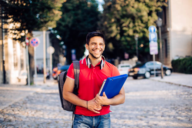 istock Portrait of a happy student enjoying his walk 1301492540