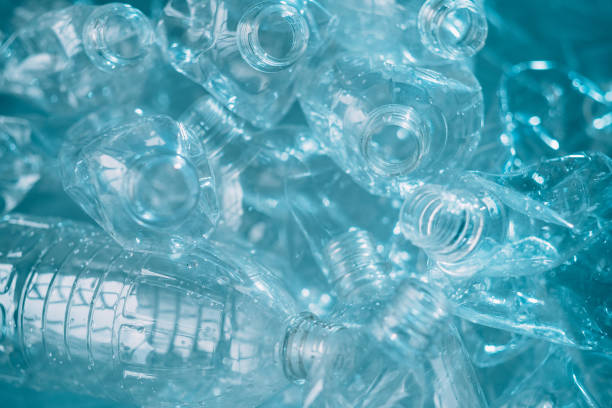 waste management plastic reuse bottles texture Waste management. Plastic reuse. Environmental protection. Save nature. Blue wet clean empty creased bottles pile texture background. wet bottle stock pictures, royalty-free photos & images