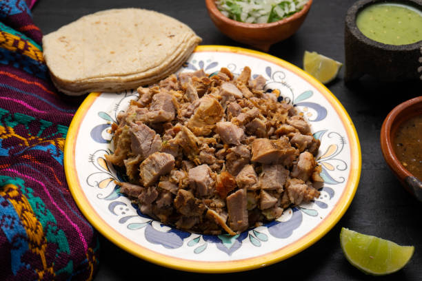 istock Confit pork called carnitas on dark background. Mexican food 1301493799