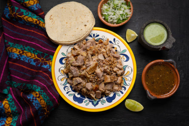 istock Confit pork called carnitas on dark background. Mexican food 1301494060
