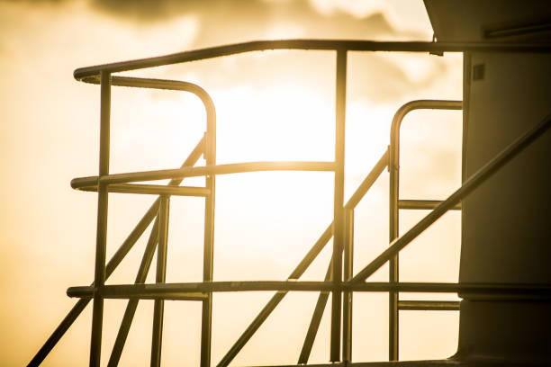 Beach lifeguard metal tower and sunset