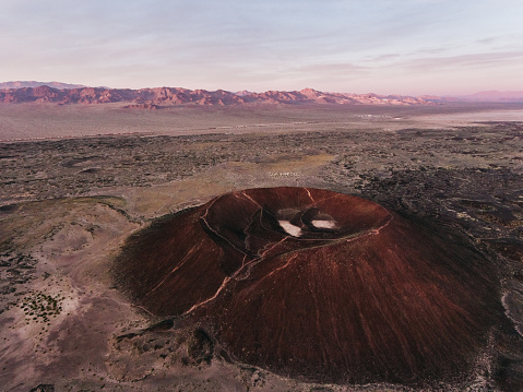 Colorful sunset view of Amboy Crater at springtime in Mojave Desert