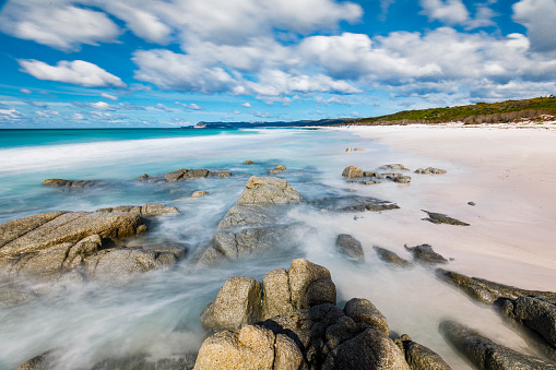 Clean ocean waves flowing over rocks on the beach, Friendly beach, Tasmania