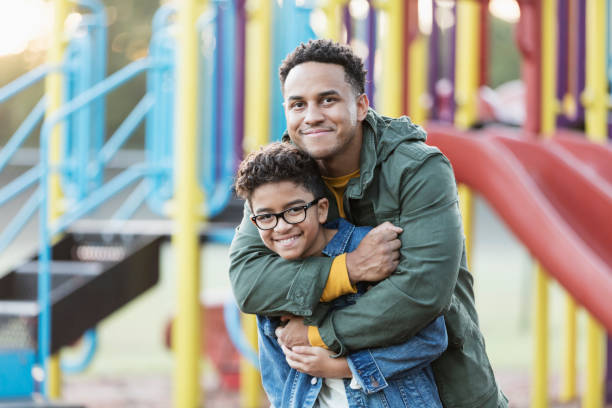 istock Mixed race boy on playground with father 1301498846