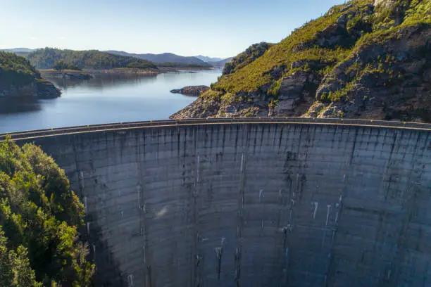Cement dam wall creating hydro electricity aerial view in Tasmania