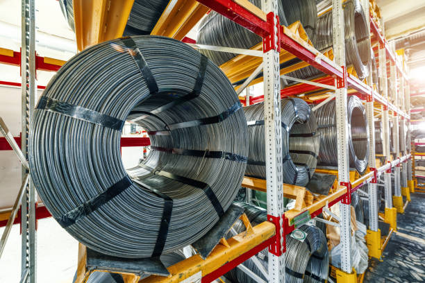 istock Factory stock wire. Wire spools lie on multi-tiered racks 1301503310