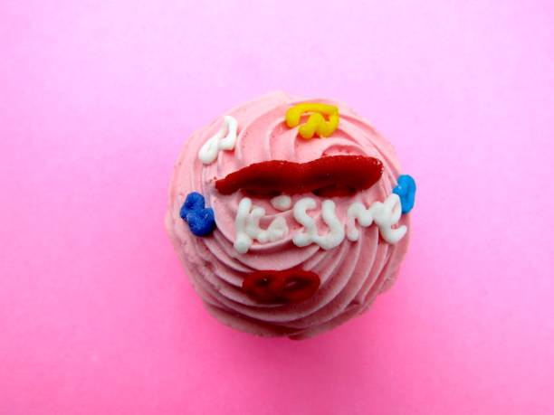 istock Kiss me words decoration on pink cupcake shaped marshmallow. 1301504955