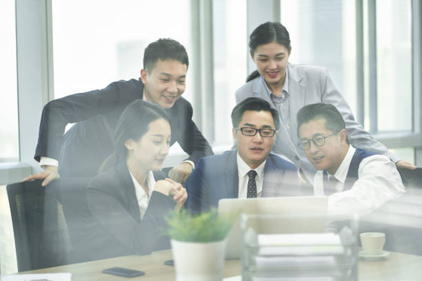 istock group of asian business people meeting in office using laptop computer 1301505026