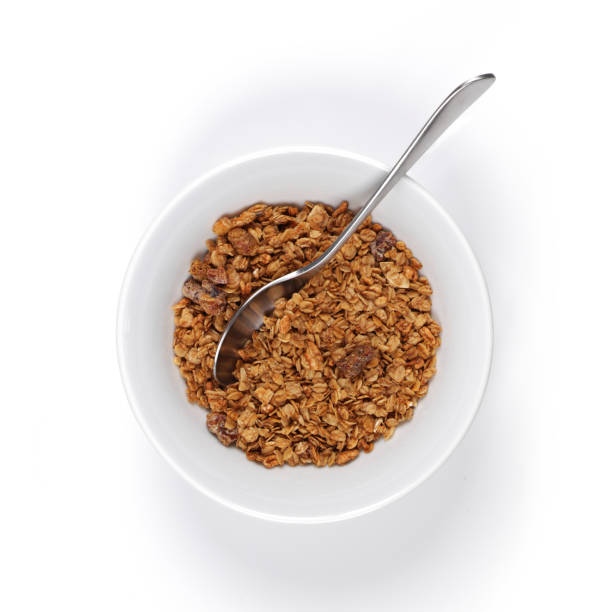 istock A white bowl of granola with spoon on white background with shadow 1301505115