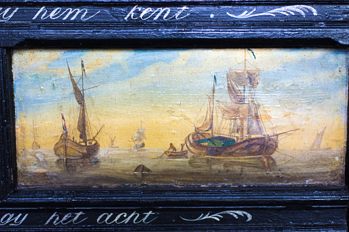 Workum, Friesland, Netherlands: An old (1700s) painting of Dutch ships at sea in St. Gertrude Church, Workum, one the 11 historic cities of Friesland.