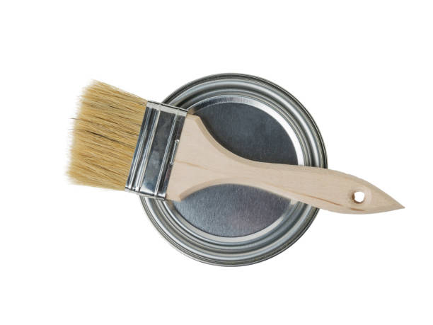 istock A brush with a wooden handle on a closed iron can of paint. 1301507667