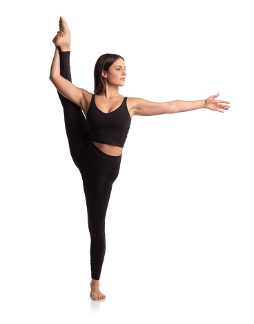 Yoga instructor showing a difficult pose standing on one leg