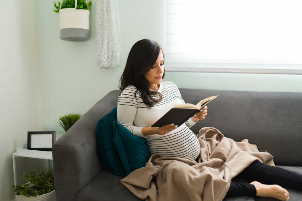 istock Expectant mother reading a book about pregnancy 1301510441
