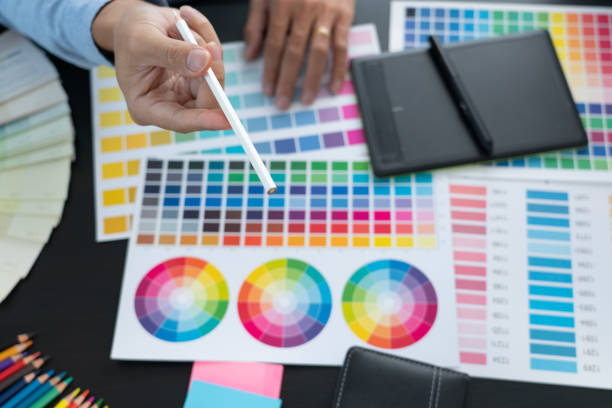 istock Graphic designer or creative working together coloring using graphics tablet and a stylus at desk with colleague 1301510936