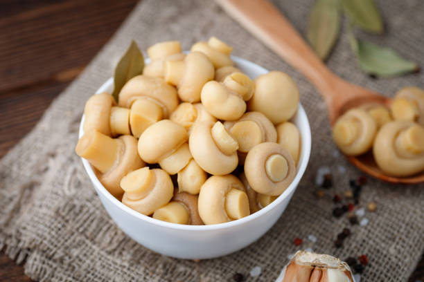 istock Pickled mushrooms - champignons in a bowl. 1301512452