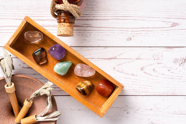 istock Top down view on seven chakra healing crystal stones for mind body and soul reiki practicing homeopathy alternative medicine on wooden table with copy space 1301512718