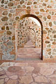 istock corridor with stone and brick arches 1301513382