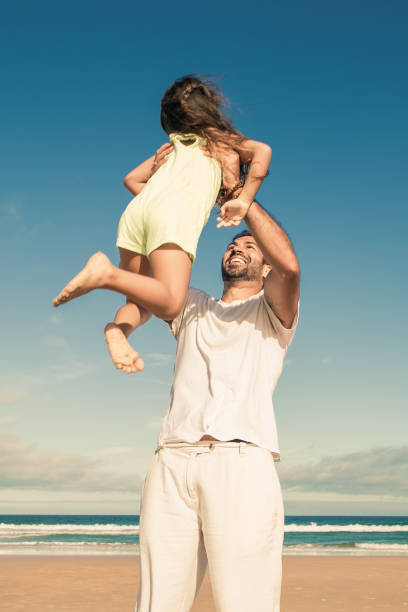 istock Joyful active dad holding little daughter in arms 1301513513