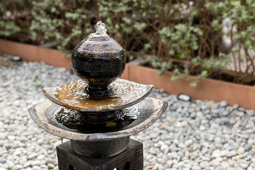 Antique fountain at garden. jar fountain in the garden. fountain in garden decoration