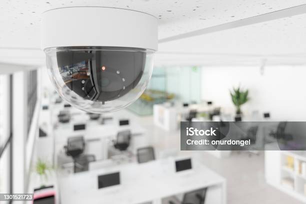 Cctv Camera In Open Plan Blurry Office Stock Photo - Download Image Now - Security Camera, Security, Security System