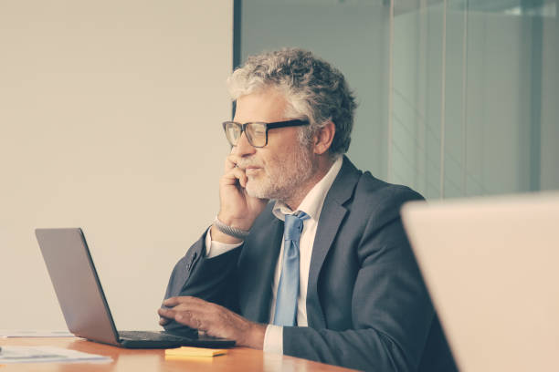 istock Serious mature professional in suit and glasses 1301522948