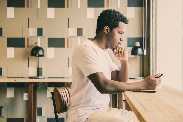 istock Focused young African American man sitting at desk 1301523718