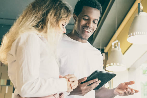 istock African American guy watching on tablet screen and laughing 1301523760