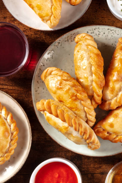 istock Empanadas with red wine and tomato sauce, overhead shot 1301523917