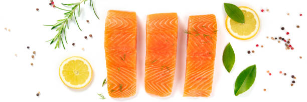 istock Raw salmon panorama with herbs, lemons and spices 1301523991