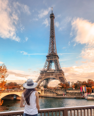 Paris, France - Nov 10 2016 : Young woman looking view of Eiffel tower at Paris in autumn season