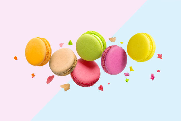 istock Colorful macaroons flying over blue and pink background. 1301529619