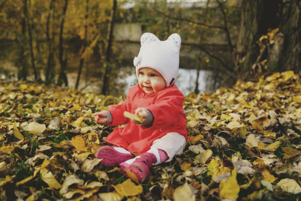 istock Child in autumn foliage takes its first steps 1301530457