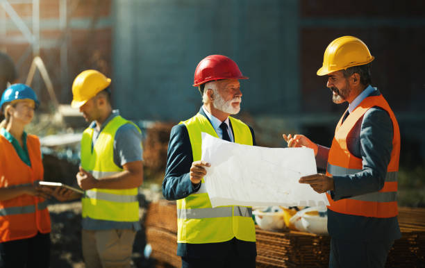 istock Group of contractors having a meeting at construction site. 1301531879