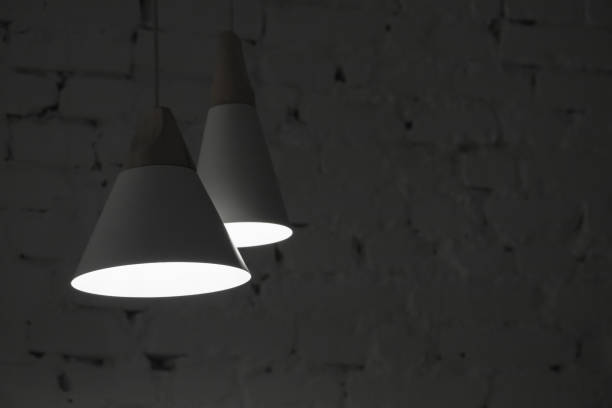 istock Two hanging spot lights in dark room 1301531925