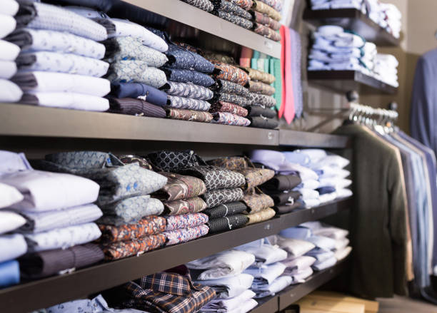 Men shirts displayed on shelves in shop