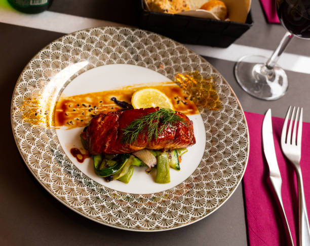 istock Salmon in soy and honey sauce with fried vegetables 1301533203