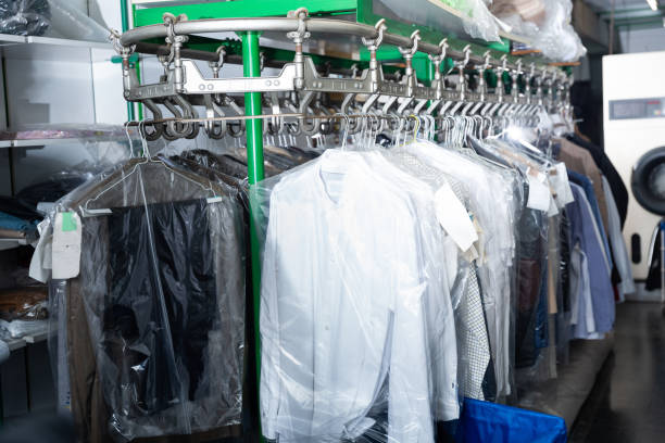 istock Clothes in plastic bags hanging at dry-cleaning 1301533279