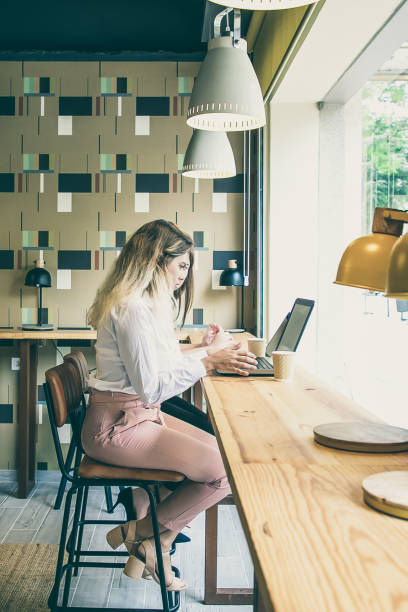 istock Young Caucasian women working on laptops and drinking coffee 1301534035