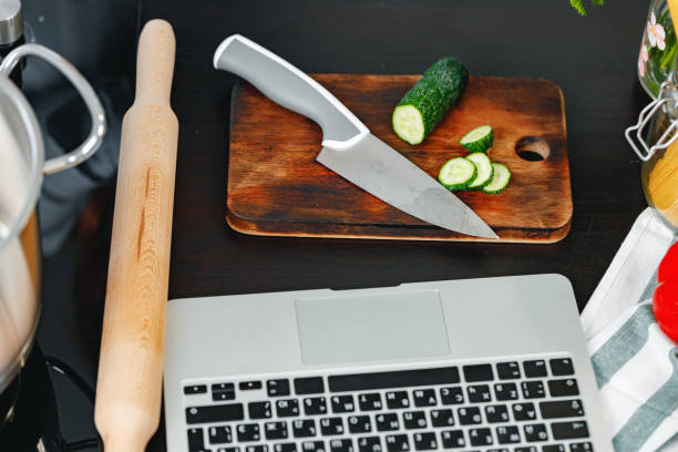 istock Top view of kitchen table with laptop and cutting board 1301535604