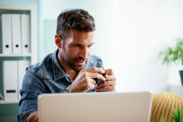istock Young businessman working on laptop and drinking coffee in his office. 1301538909