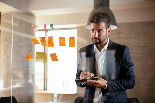 istock Young businessman in suit making a business plan. 1301539237